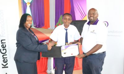 KenGen Board Member, Winnie Pertet (L) and KenGen Foundation Managing Trustee Anthony Igecha (R) presenting a scholarship award to a student beneficiary.